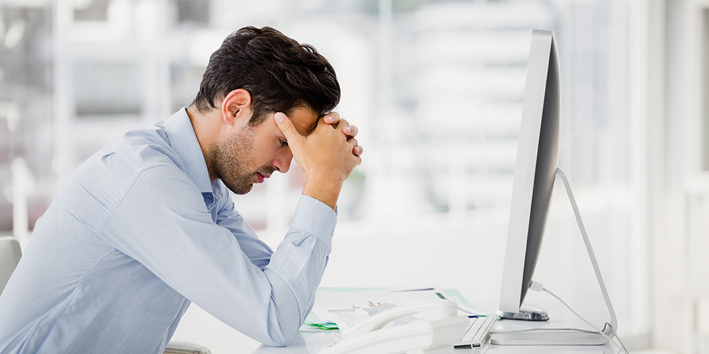 Businessman frustrated at computer screen